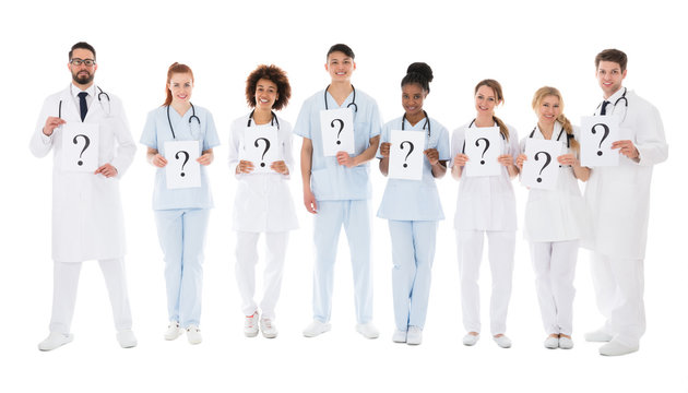 Group Of Multiracial Doctors Holding Question Mark Sign