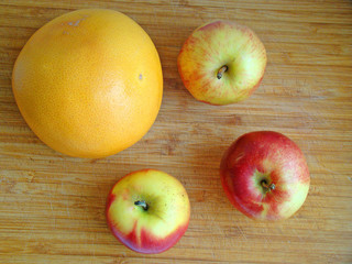 Naklejka na ściany i meble Apples and grapefruit on the table