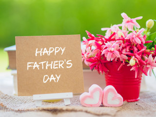 Father's day concept. Poster mock up template with flower bouquet, marshmallow in the shape of heart and books over green background with Happy Father's day text