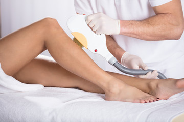 Laser Treatment At Beauty Clinic On Woman's Leg