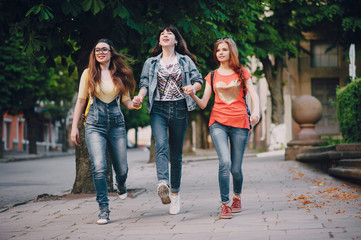 three young girls walking in the park