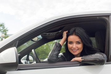 Young Woman Sitting Inside Car Smiling at Camera