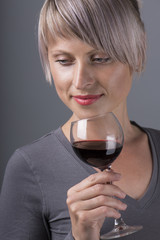 Closeup portrait of young female customer drinking red wine with eyes closed