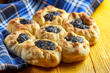 Beautiful appetizing buns with poppy seeds and raisins. Hamantashen / Hamantash - traditional Jewish sweet. Sweet pies with filling from Israel. Cake for tea.