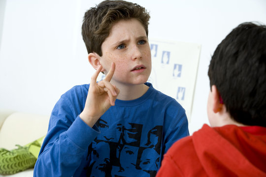 Models Do not use for HIV A young boy using the French sign language to discuss with his hearing-impaired brother The French sign language uses signs to designate words but also dactylology (each letter of the alphabet is represented by a defined position of the fingers then enabling to spell a word) and the lip reading The young boy designates the letter \h\ (see image nﾰ0833202 and series of images from nﾰ0572308 to 0573508 to see the other letters of the alphabet)