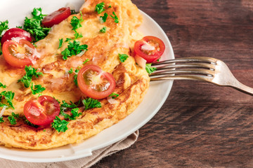 Omelette with parsley, cherry tomatoes, and copyspace