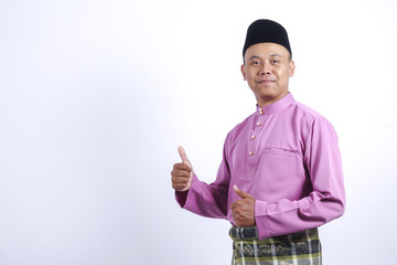 Man in traditional clothing, standing  celebrate Eid Fitr.