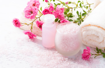 Spa setting with   branch of  small  pink roses.  Selective focus