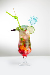 Glass of red ice tea with mint and lemon isolated