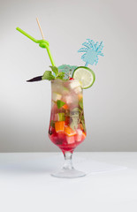 Glass of red ice tea with mint and lemon isolated