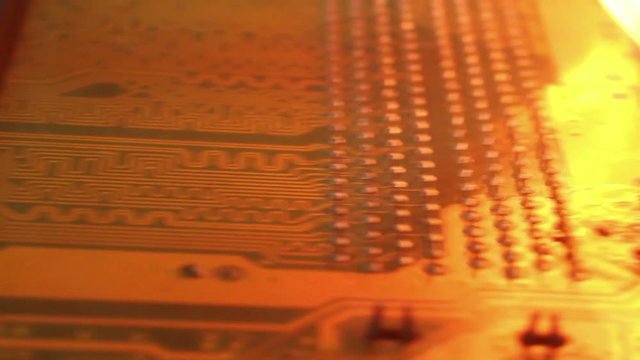 Low angle dolly along burning computer motherboard, with variations . One of a series