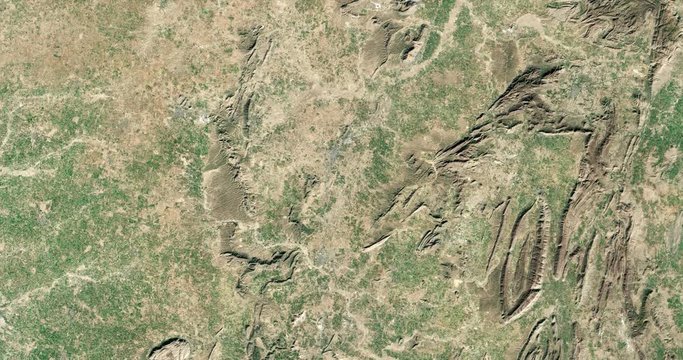 High-altitude overflight aerial of the Aravalli range and surrounding land, India. Clip loops and is reversible. Elements of this image furnished by USGS/NASA Landsat
