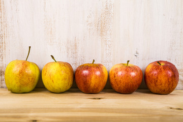 Red apples on a wooden table.