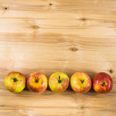 Red apples on a wooden table.