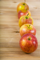 Red apples on a wooden table.