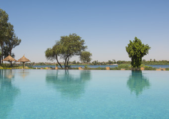 Obraz premium Swimming pool at a luxury tropical hotel resort