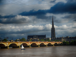 Stone Bridge and White sailing Boat In Bordeaux France