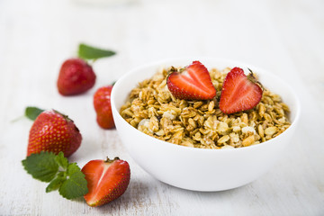 Granola with strawberry on a wooden table