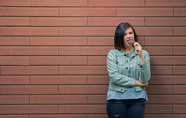 Young beautiful girl eating chocolate ice cream on a stick