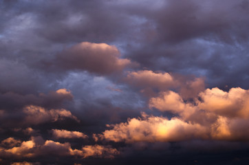 Naklejka na ściany i meble Storm clouds in the sunset light