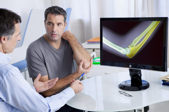 Male patient consulting for elbow pain