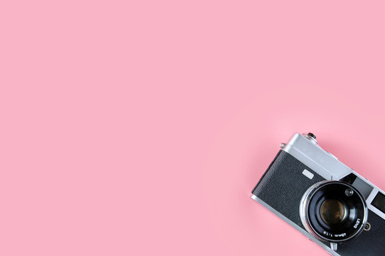 Old film camera vintage on pink background,minimal concept,Copy space