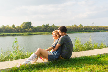 Fototapeta premium Portrait of happy girl hugging her boyfriend outside.