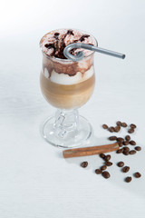 Glass of cold latte coffee topic cocolate cream on isolated white background with desserts