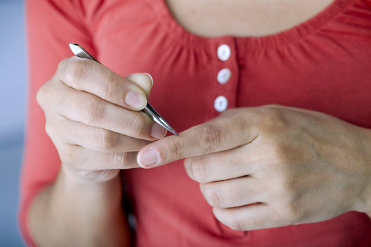 Woman Removing A Splinter