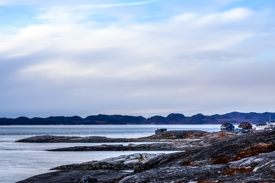 Arctic fjord panorama with houses at the stony tundra shore in a suburb of Nuuk, Greenland
