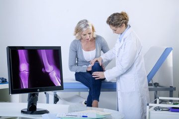 Doctor examining patient's knee