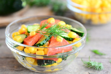 Quick vegetable salad. Homemade salad cooked from fresh cucumbers, tomatoes and canned corn and garnished dill sprig. Vegetarian vitamin salad idea. Closeup