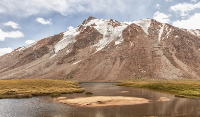 Landscape of mountains and glaciers in the sunny weather. mountain river, lake.