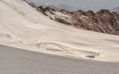 Landscape of mountains and glaciers. closeup a glacier, a lot of snow near the rocks.