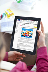 Woman reading an article about buying medicines online