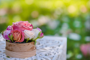 Wedding rings lay on the flower composition for the ceremony