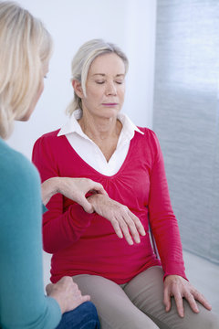 Senior woman undergoing hypnosis session