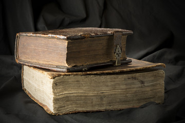Old books on black background. Ancient christian Bible. Antique Holy Scripture books. Pile of books with page sides.