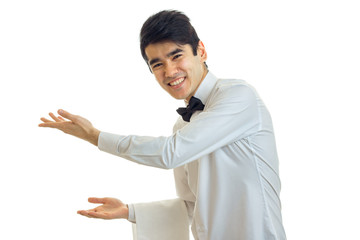 joyful handsome waiter reaches out his hands forward and invites people