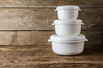 Empty containers for food on wooden background