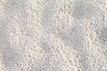 Top view of sand pattern of a beach, background with copy space and visible sand texture
