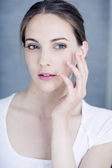 Woman applying cream to treat labial herpes