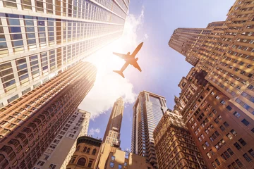 Zelfklevend Fotobehang plane over highrise buildings © Felix Pergande