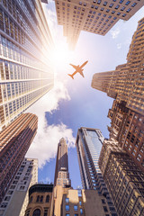 Obraz na płótnie Canvas plane over highrise buildings