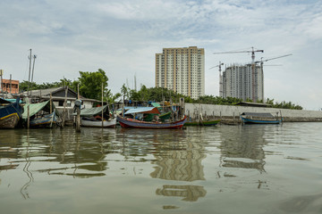 Fototapeta na wymiar Sunda Kelapa old Harbour with fishing boats, ship and docks in Jakarta, Indonesia