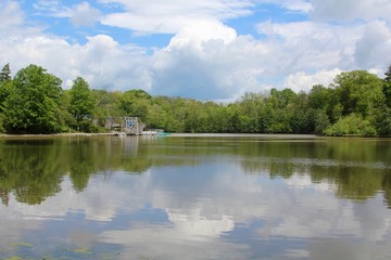 The boathouse and the reflecting clouds on the lake.