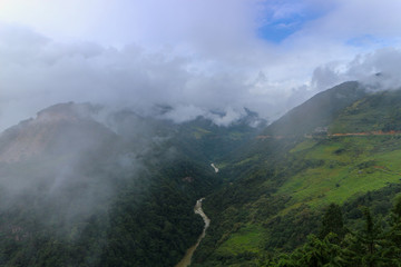 Scenery of foggy hills and Mangde River in Bumthang, Bhutan