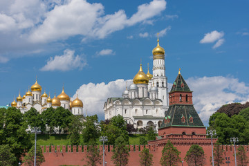 Fototapeta na wymiar Architectural ensemble of Moscow Kremlin from Sofiyskaya embankment of Moskva River with beautiful kremlin churches and Taynitskaya Secret Tower.