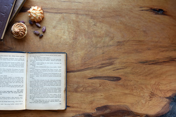 old books and cookies on wood background