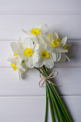 Background with white narcissus  on white wooden  background